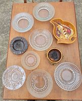 All ten ashtrays displayed on table