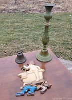 Full lot view of candleholder, bell and wall plaque