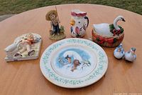 Overall lot showing all eight ceramic items on table