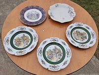 All five decorative plates displayed on table