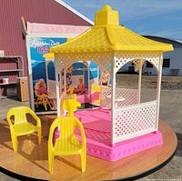 Overall view of assembled gazebo with chairs and box