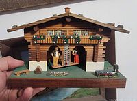 Front view showing chalet, thermometer, figures and décor