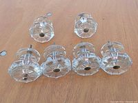 six clear glass drawer pulls arranged face up