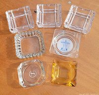 All seven ashtrays arranged on table