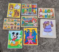 All eight wooden puzzles laid out on concrete