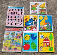 All seven wooden puzzles laid out on ground