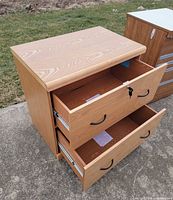 Cabinet with drawers open showing hardware and wood finish