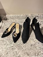 Both pairs of black pumps on countertop