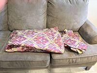 Folded unfinished quilt on sofa