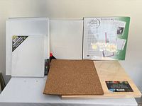 Group view of canvases, artist panel, cork panel, scrapbook pages, easel