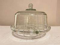 Glass cake stand with dome in place