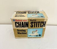 Front of boxed Belna mini electric chain stitch sewing machine