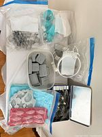 overview of bags and containers holding cookie cutters, molds and piping tips