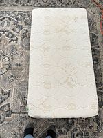 Top view of white foam crib mattress