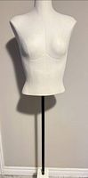 Front view of white fabric female torso mannequin on stand