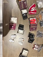 Overview of table with multiple boxed and bagged doll shoes