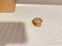 Side view of single unfinished wood knob
