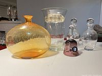 Front view of all six glass items showing shapes and colors