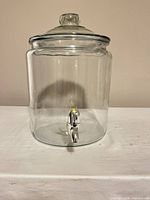 Front view of glass dispenser with lid and spigot