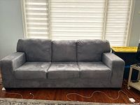 Front view of grey microsuede three-seat sofa