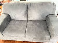 Front view of grey microsuede loveseat showing overall style and cushions