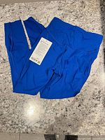 Full view of blue leggings with tag attached