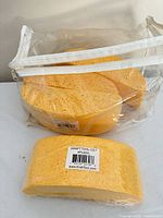 Clear zip bag holding three yellow masonry sponges with visible Kraft Tool Co. barcode label