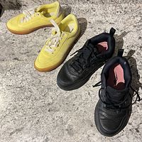 Yellow and black sneakers side by side on countertop