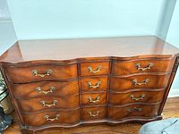 Front view showing 12 drawers and brass hardware