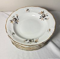 Stack of bowls showing floral pattern and gold trim