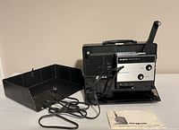Projector with cover removed and manual