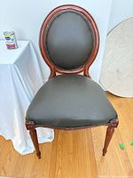 Front view of wood chair displaying frame, upholstery, and overall style