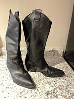 Full view of both boots standing, showing leather, height, pointed toe, Cuban heel