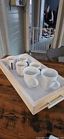 Wooden tray with six mugs overall view