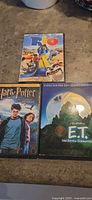 Front view of three DVD cases: Rio, Harry Potter and the Prisoner of Azkaban, E.T. 2-Disc Edition