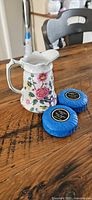 Old Foley Chinese Rose pitcher with two blue-wrapped guest soaps on wooden table