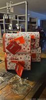 Stack of four Snoopy Valentine tin mailboxes showing design and tags