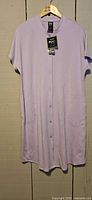 Full front view of lavender button-front bamboo dress/nightgown on hanger with tags attached