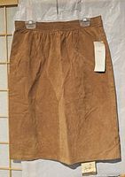 Front view of brown suede leather skirt with tag attached