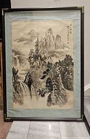 Full view of framed painting showing artwork, mat, frame and brass corners