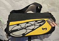 Front view of yellow and black Phat Farm shoulder bag showing full design and strap