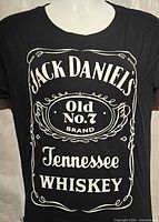 Full front view of black Jack Daniel's graphic T-shirt on mannequin