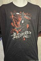 Full front view of black t-shirt showing entire graphic and text