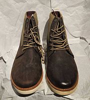 Front view of both boots showing leather uppers, laces, outsole