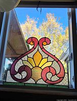 Full view of stained glass panel leaning in window