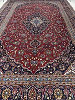 Full view of the Kashan rug showing entire pattern and size