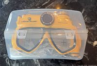 Mask inside clear case showing brand and model