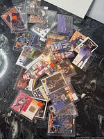 Spread of sleeved Vince Carter trading cards scattered on countertop