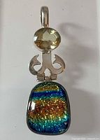 Front view showing citrine, hinged silver element and multicolour dichroic glass