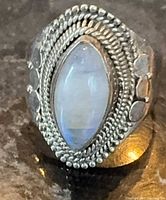Front view of sterling silver ring showing marquise moonstone and beaded border